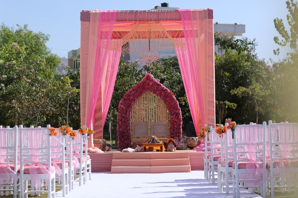 Photo of Outdoor morning sikh wedding decor with pink drapes