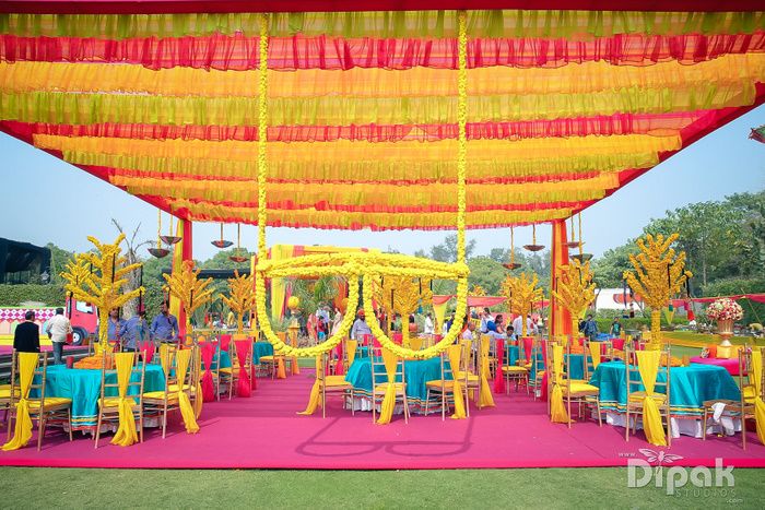 Photo of Colourful Mehendi Decor with Genda Phool Sunglasses