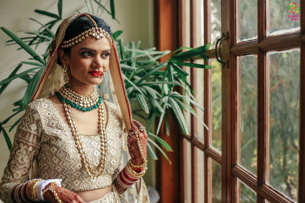 Photo of Offbeat bride in off white and gold lehenga