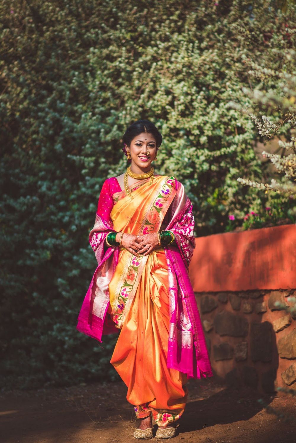 Photo of A beautiful Marathi bride in pink & yellow nauvari saree.
