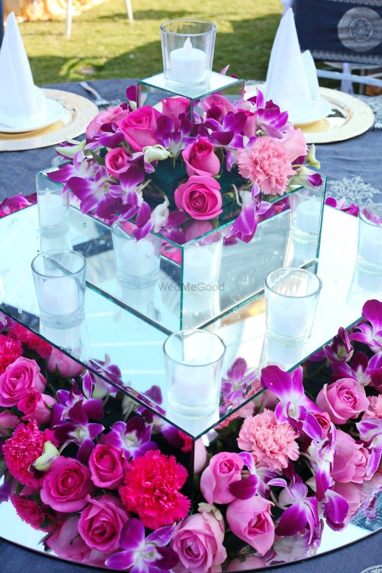 Photo of Purple table setting with candles and flowers