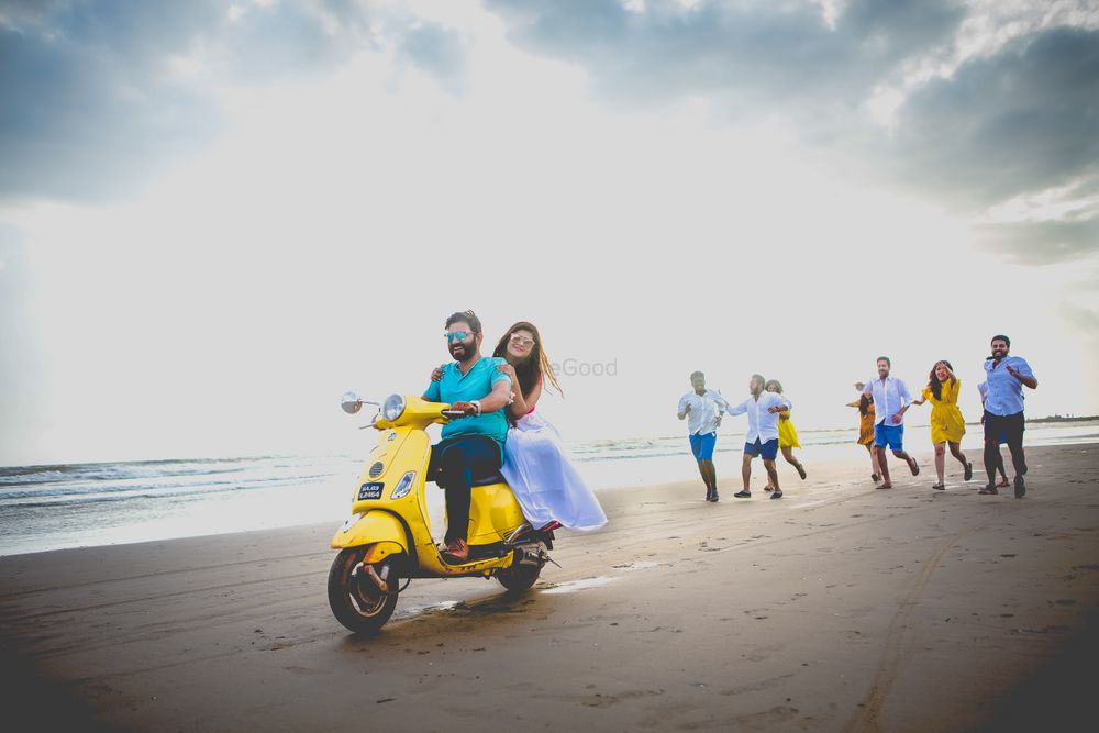 Photo of Beach pre wedding shoot couple on scooter and friends