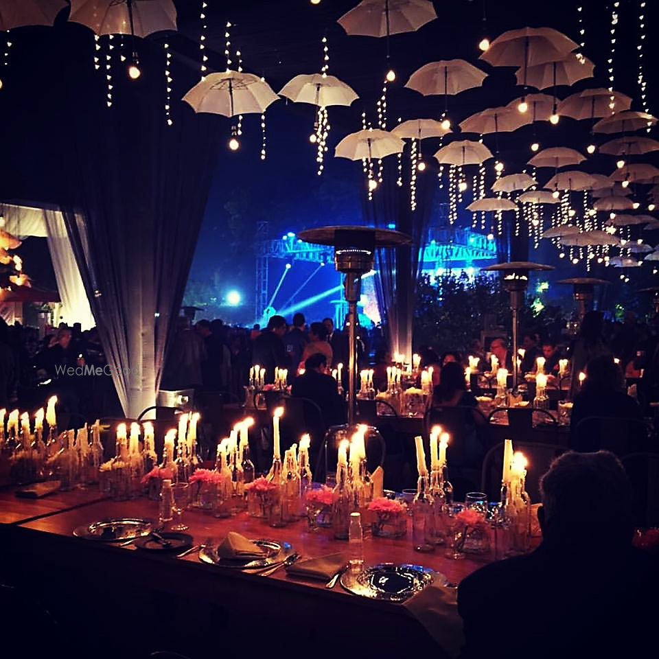 Photo of Reception umbrellas and candles lit decor