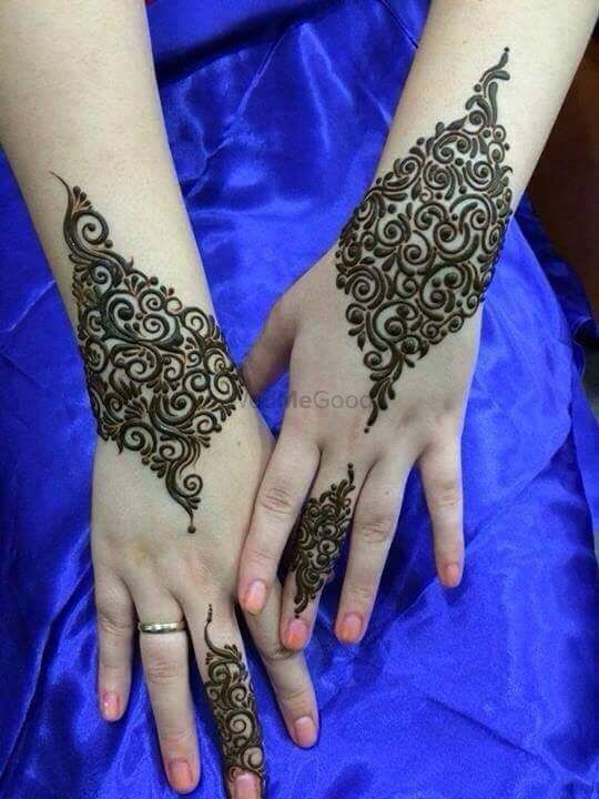 Photo of Spaced out modern mehendi design on back of the hand
