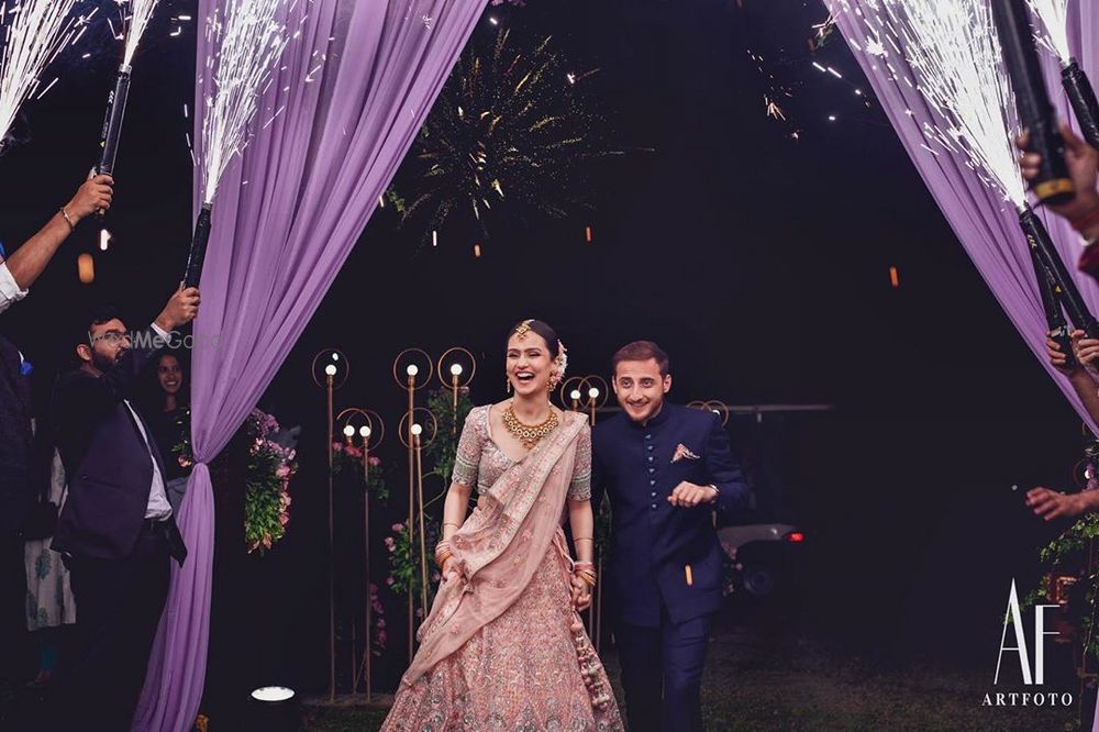 Photo of Bride and groom walking hand in hand.