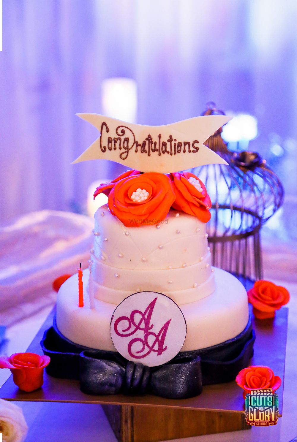 Photo of Wedding cake with orange roses and monogram logo
