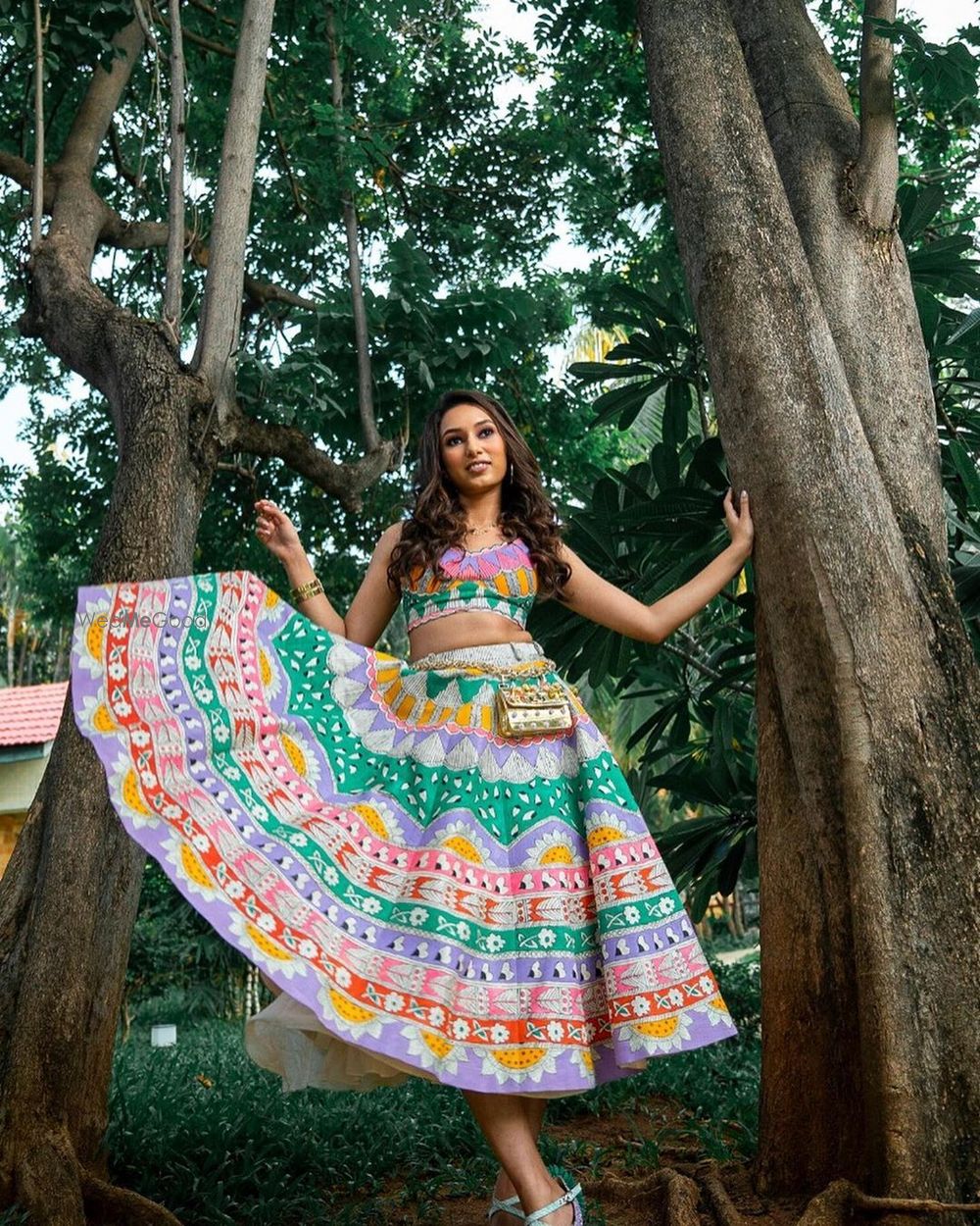 Photo of Bride wearing a short multicolored lehenga.