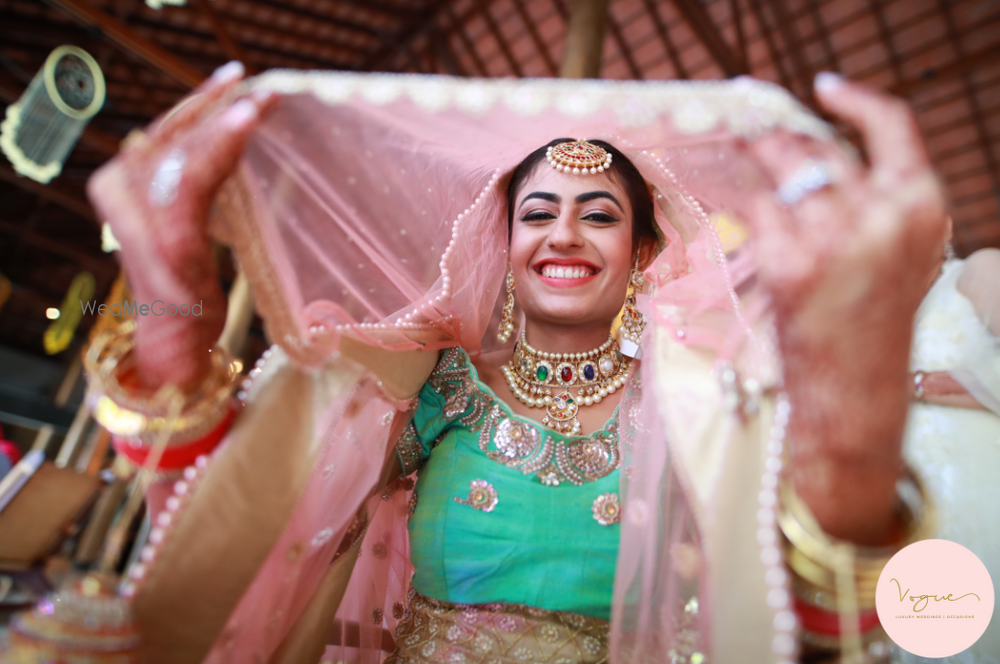 Photo of Fun bridal portrait with bride in pink and aqua lehenga