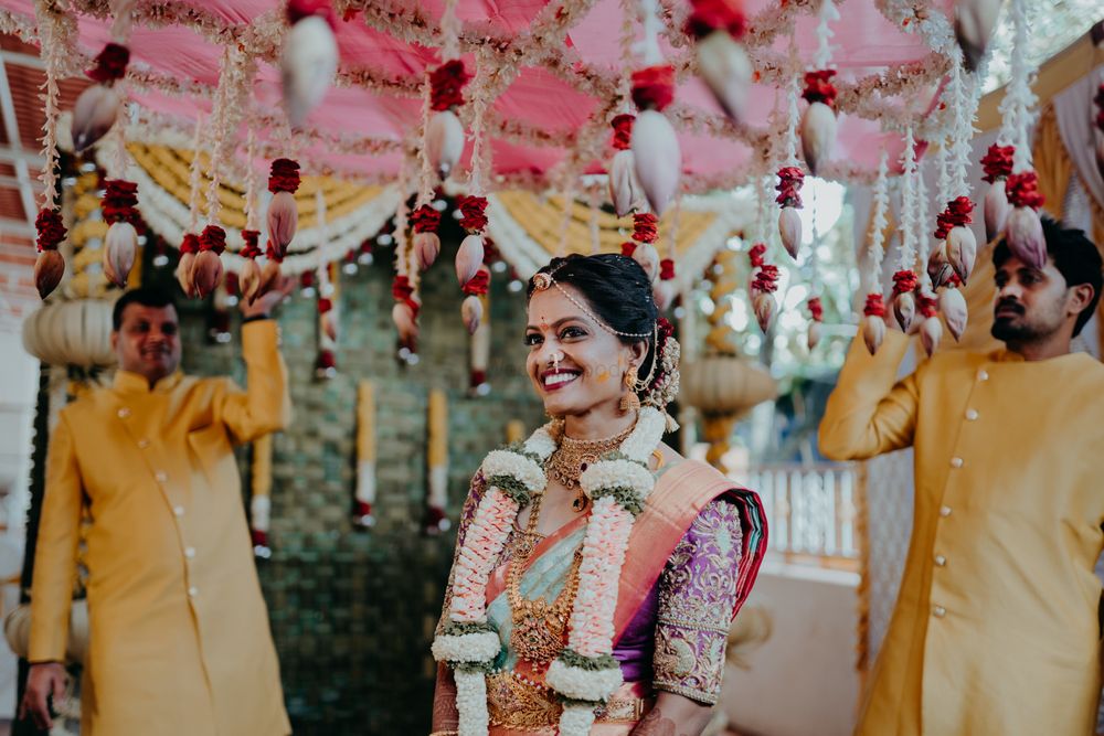 Photo of South Indian bridal entry under a phoolon ki chaadar.