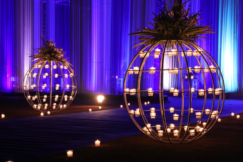 Photo of Candles in orb-like installations.