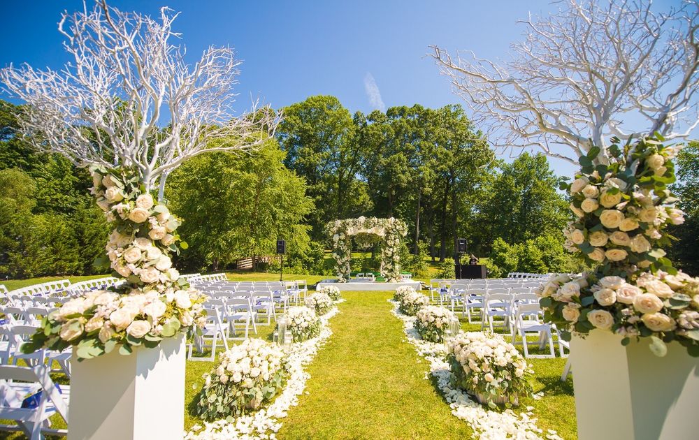 Photo of Beautiful floral decor in white for an outdoor wedding