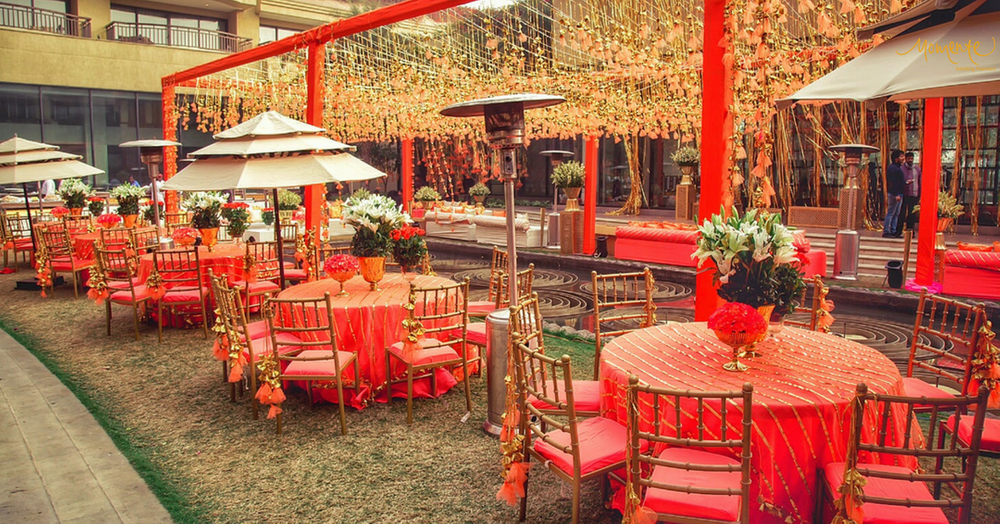 Photo of Orange theme round table setting idea