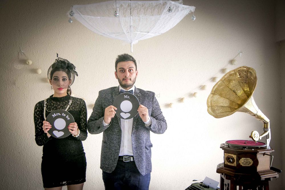 Photo of Fun vintage pre wedding shoot with props