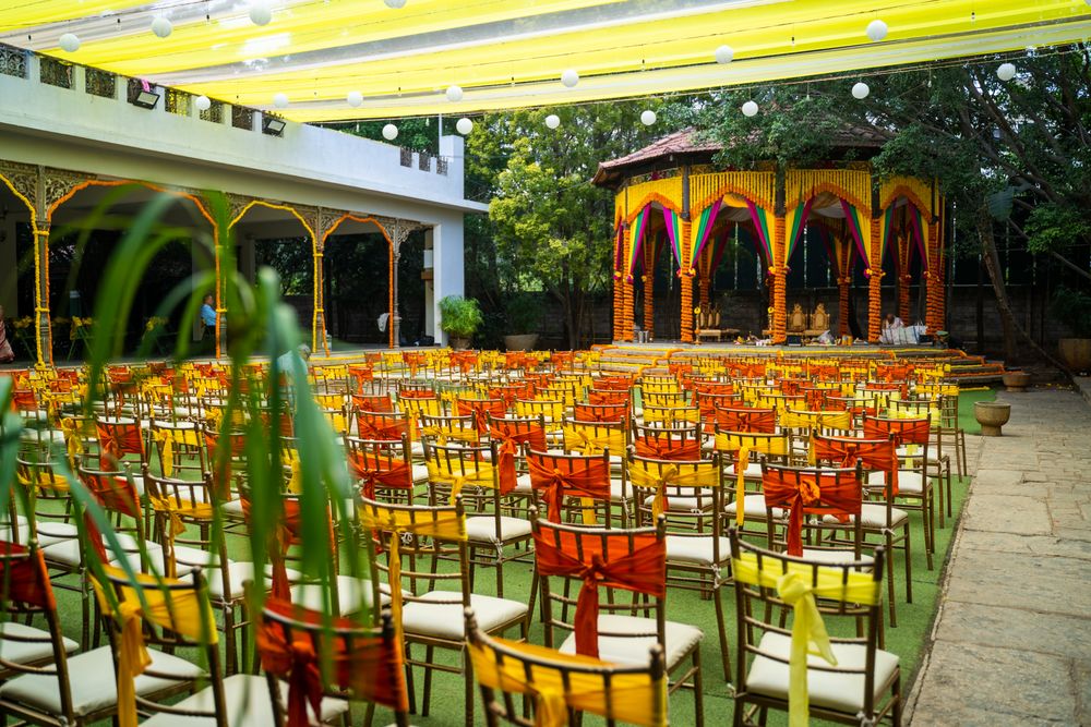 Photo of matching orange and yellow mandap and chair decor for south indian wedding