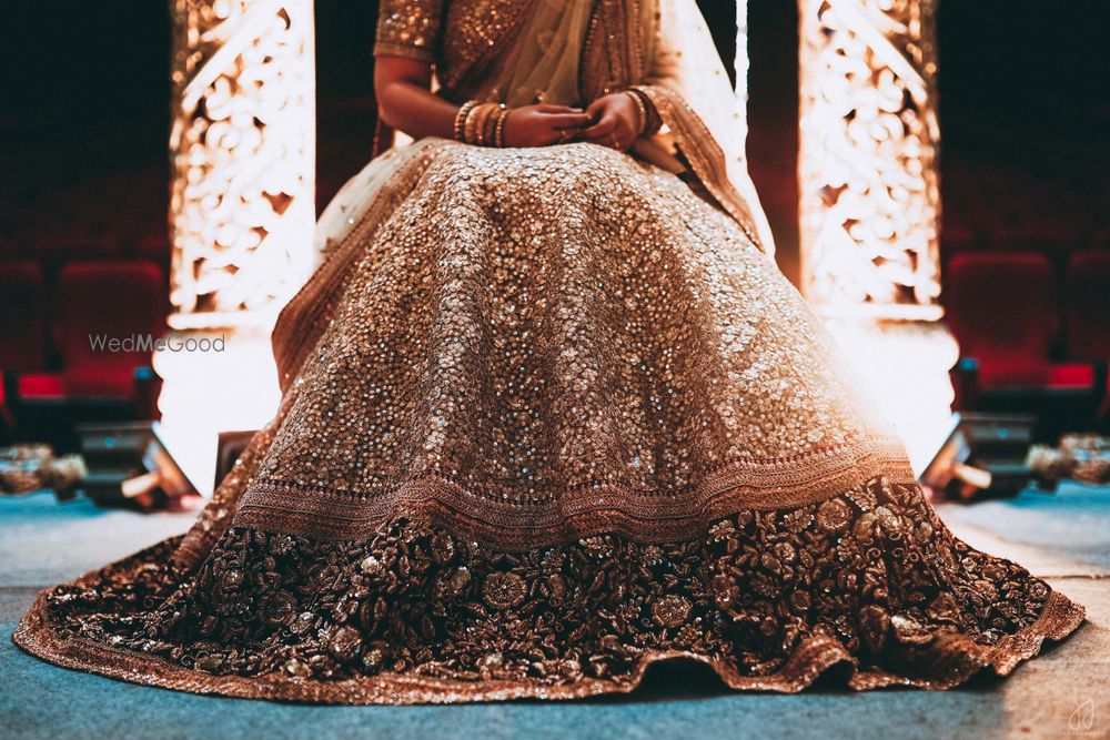 Photo of Gold sequin lehenga with navy blue border