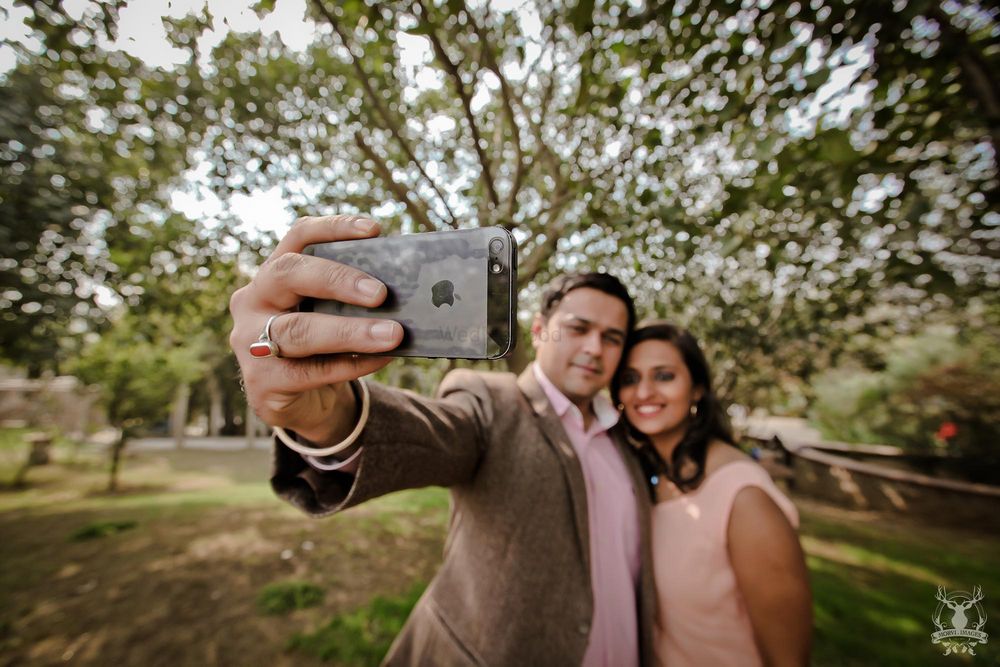 Photo of couple taking selfie pre wedding shoot