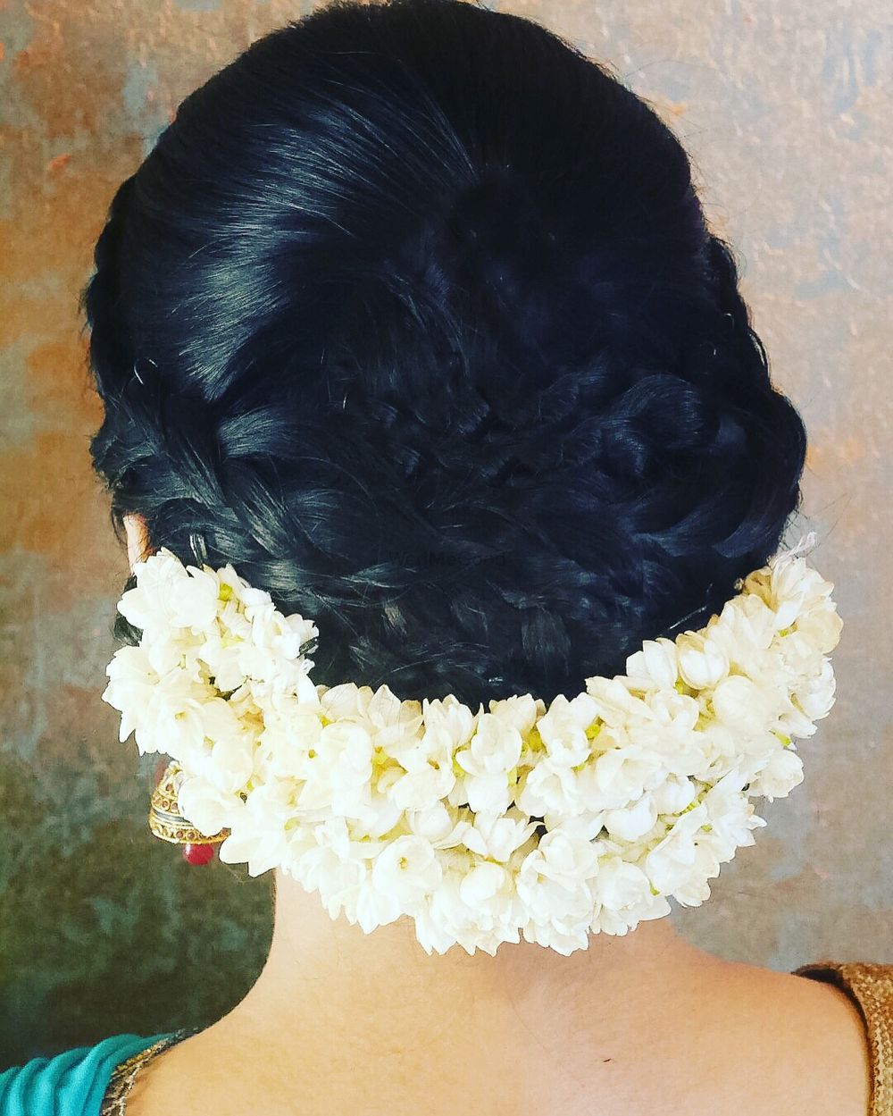 Photo of Low braided bun with gajra at the bottom