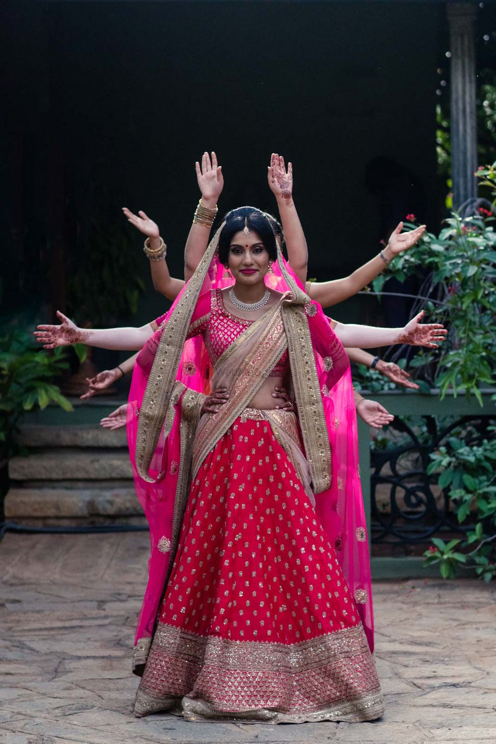 Photo of Bride in hot pink lehenga with filmy pose