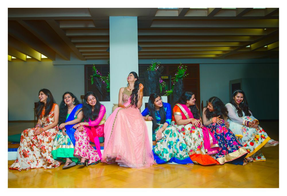 Photo of Bride with bridesmaids in coordinated floral lehengas