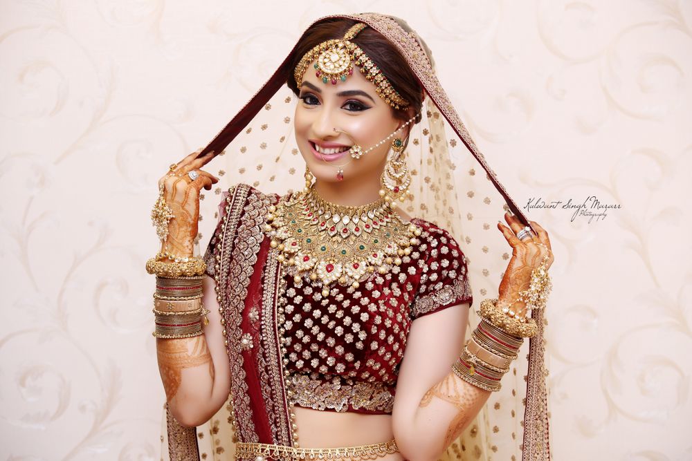 Photo of Bride in gold and marsala lehenga posing with dupatta