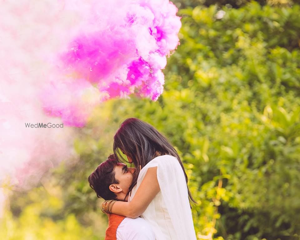 Photo of Pre wedding shoot with pink smoke bomb prop