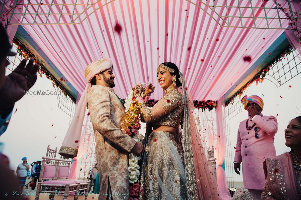 Photo of Coordinated bride and groom during jaimala