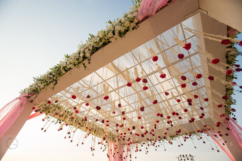 Photo of Light pink and white mandap with hanging floral strings