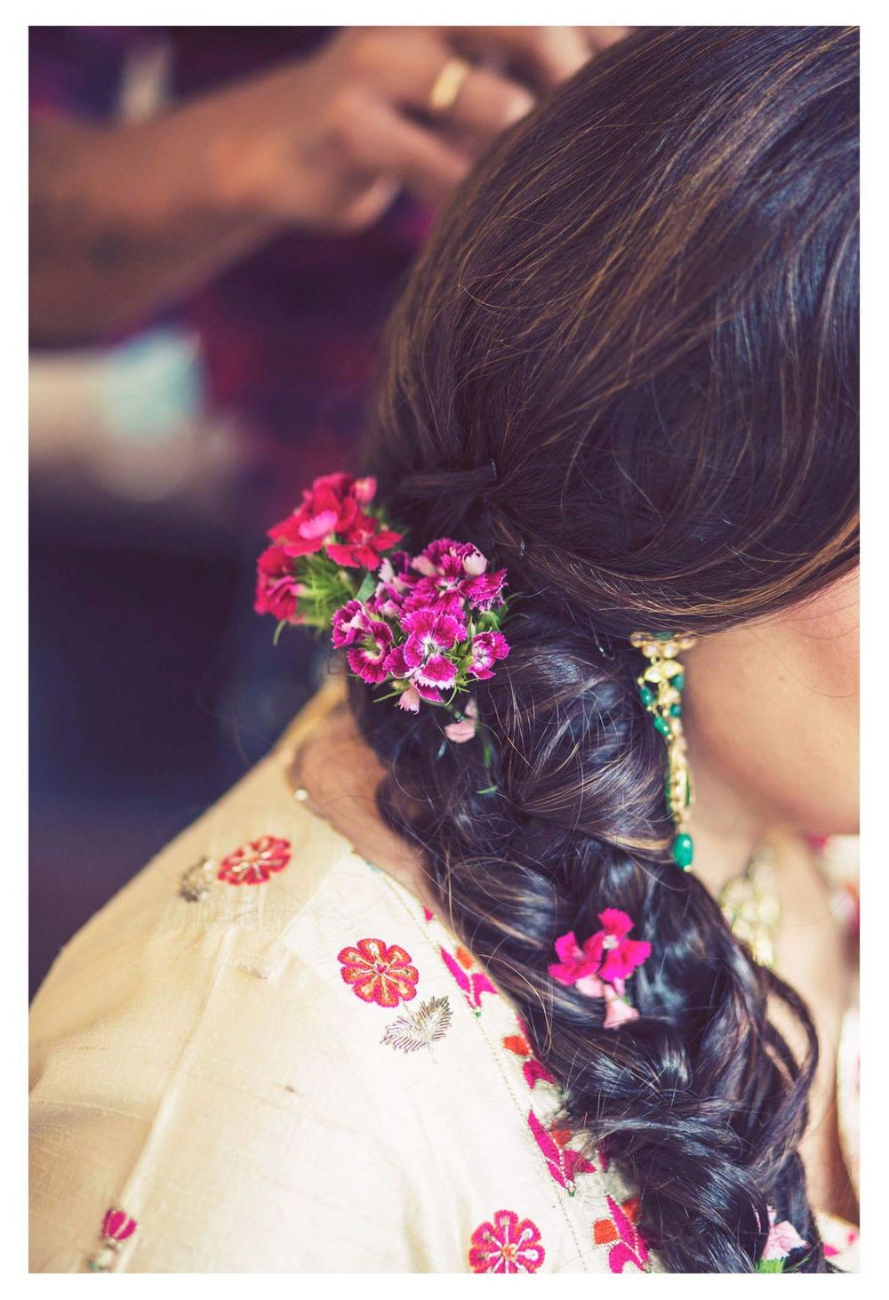 Photo of Side braid with small pink flowers for mehendi