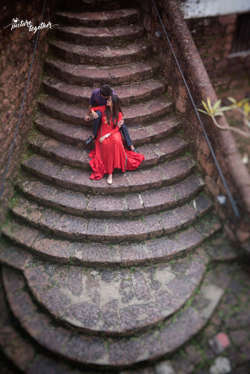Photo of Top shot pre wedding shoot with couple on staircase