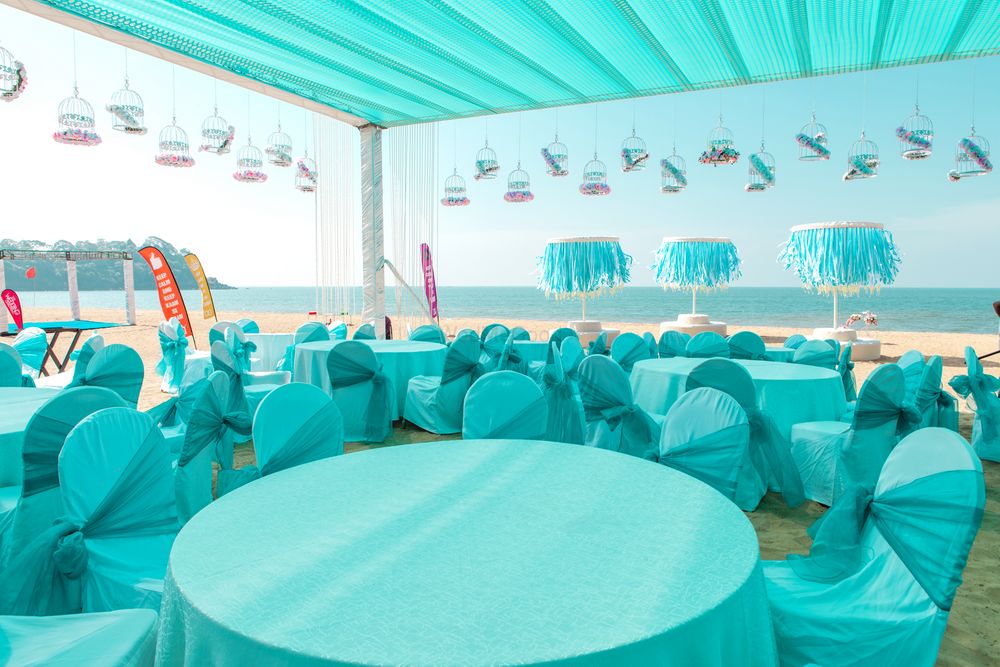 Photo of turquoise beach wedding table settings