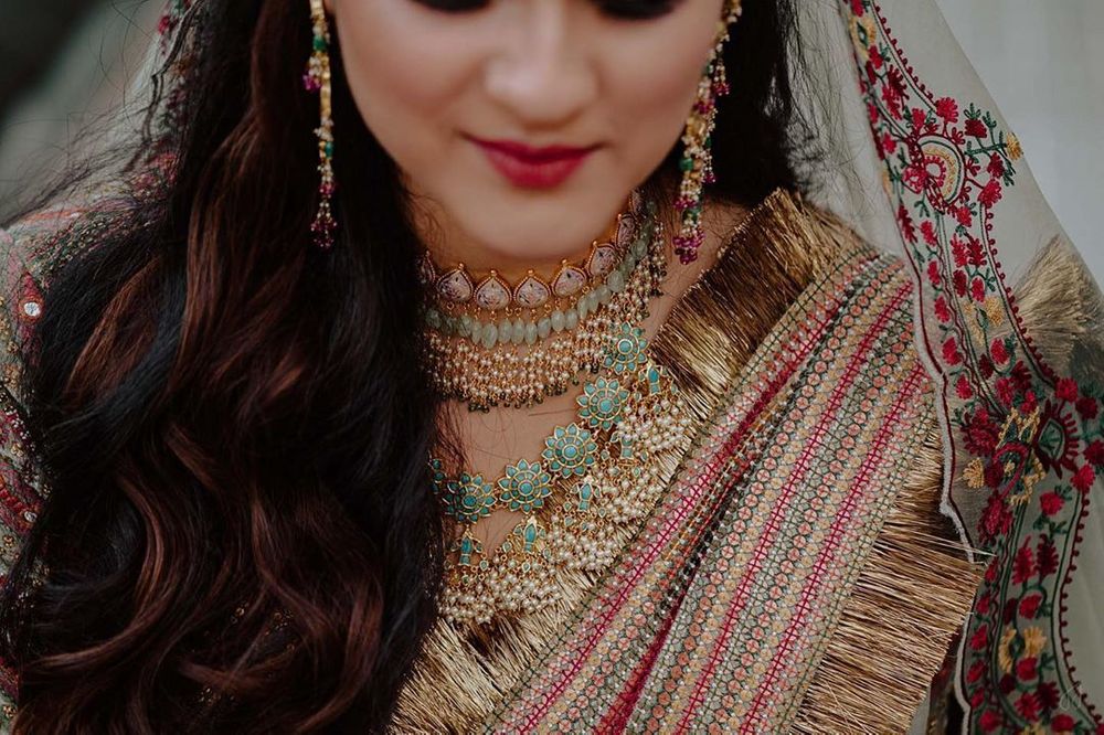 Photo of Bride wearing a choker with an enameled necklace.