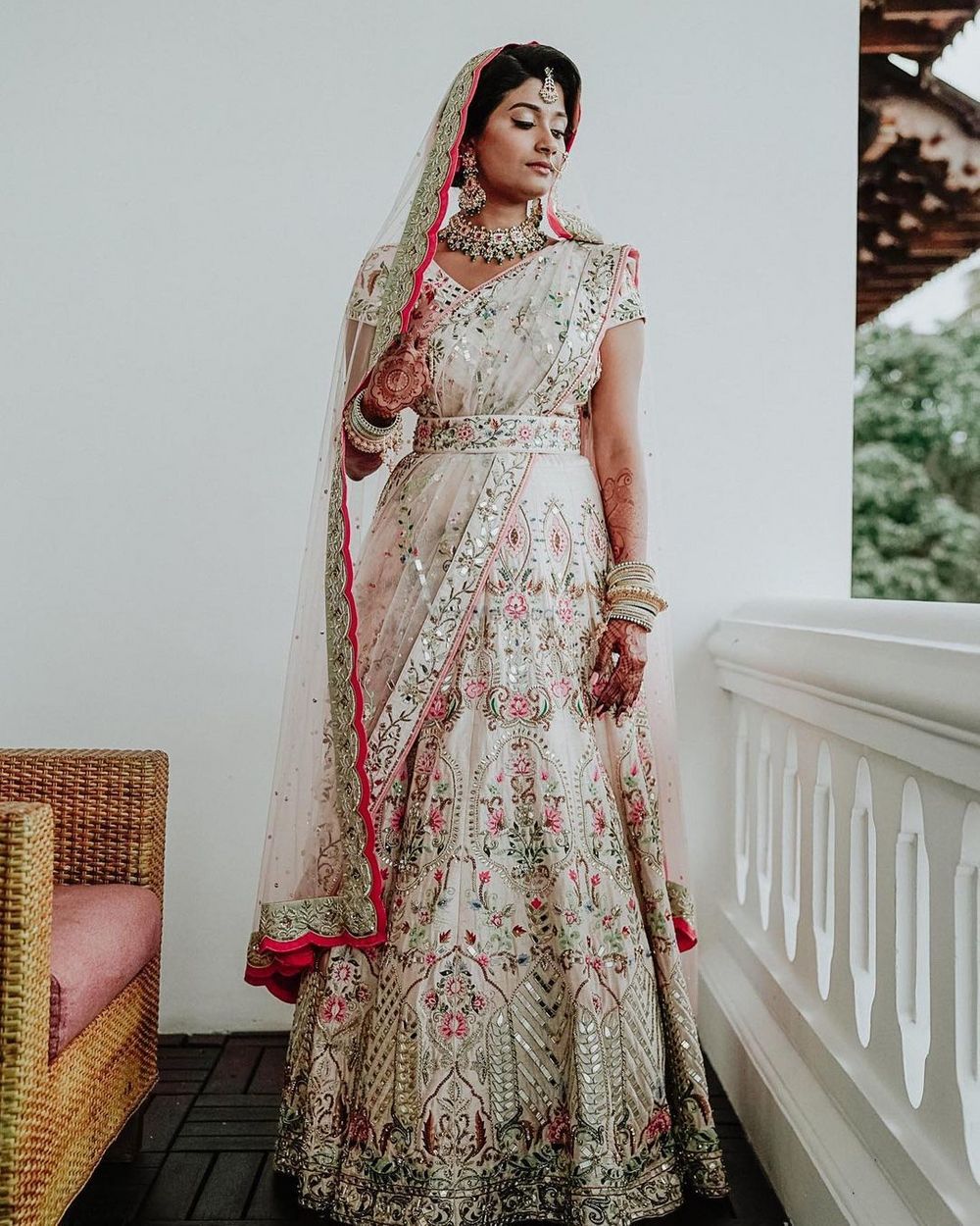 Photo of Bride dressed in ivory belted lehenga for her wedding.