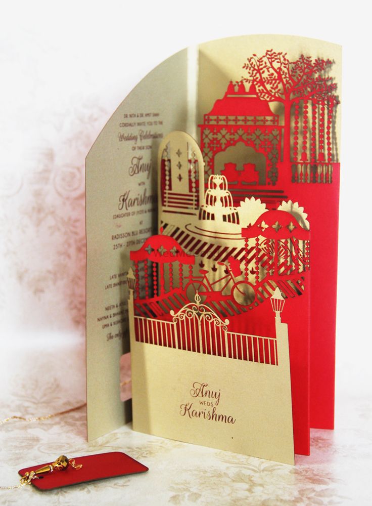 Photo of Red and gold laser cut layered wedding card