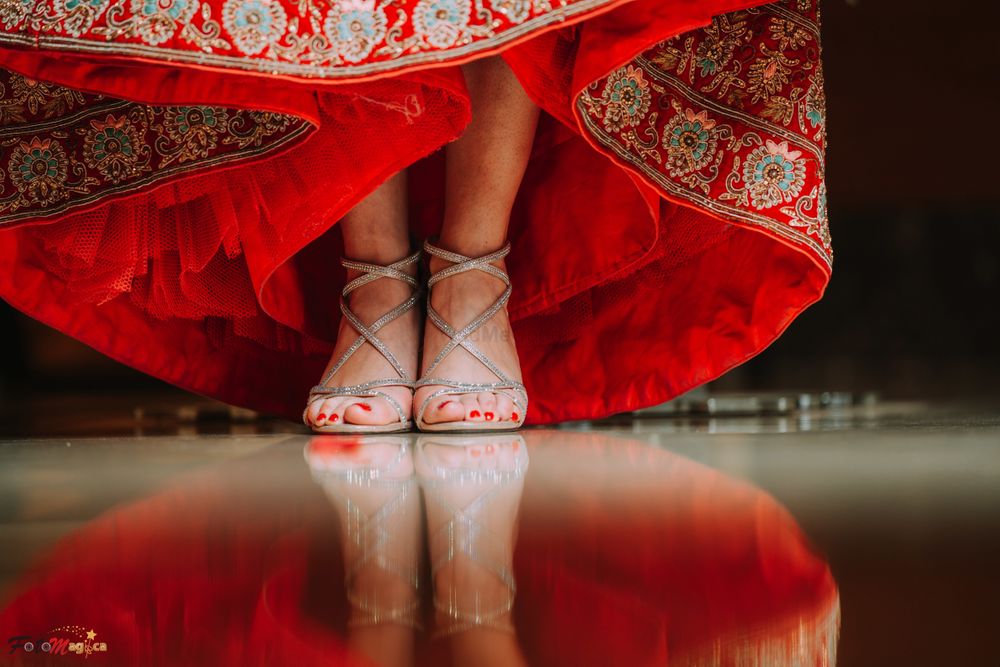 Photo of strappy silver bridal heals under red lehenga
