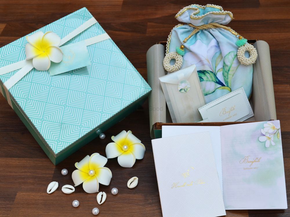 Photo of Elegant turquoise wedding invite box with potlis for favors