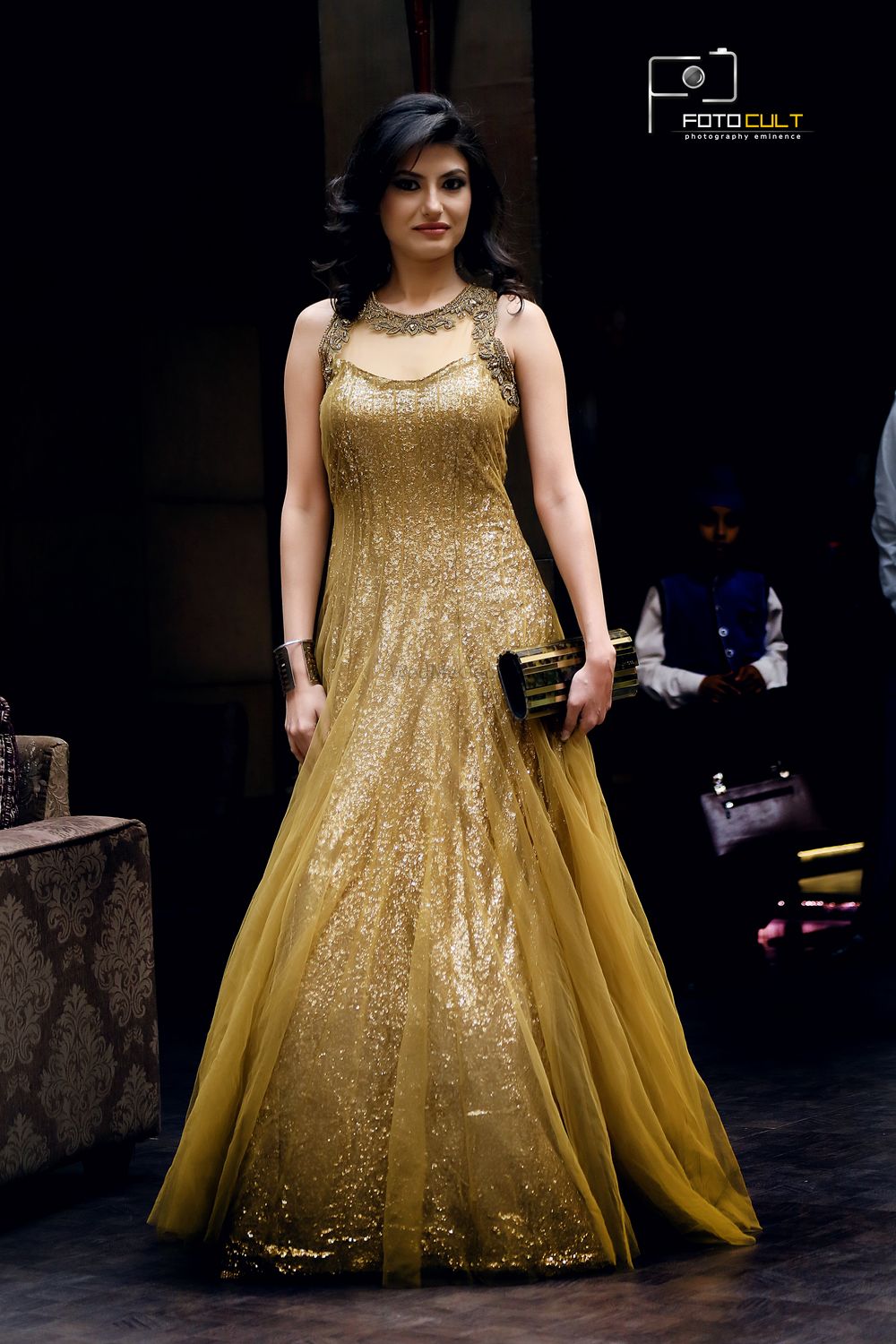 Photo of floor length shimmery gold gown with net overlay