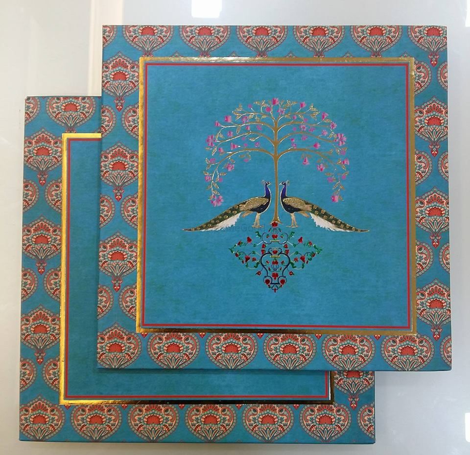 Photo of Simple blue wedding card with peacock motif