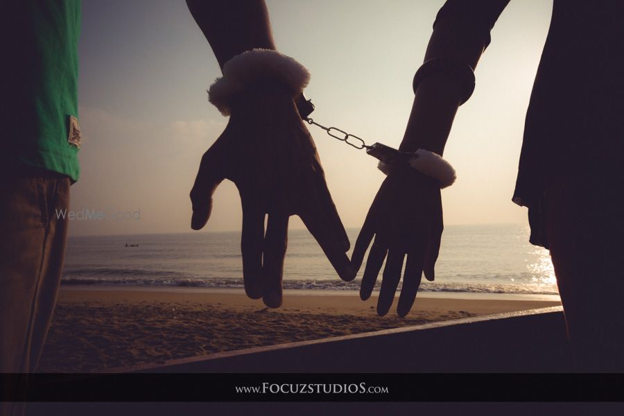 Photo of handcuffed pre-wedding shoot