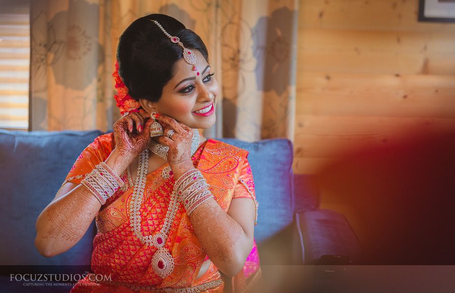 Photo of coral and red south indian bridal saree