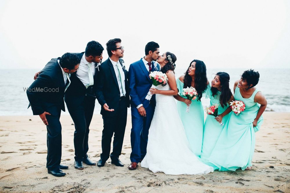 Photo of Couple on the beach with bridesmaids and groomsmen