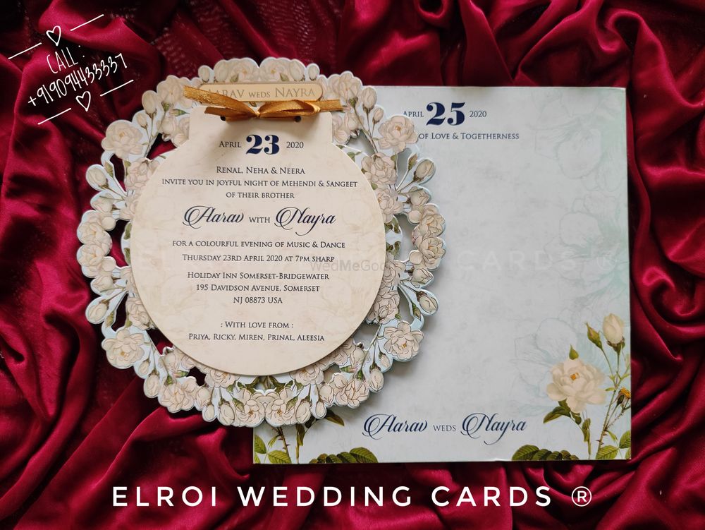Photo From Beautiful floral design round die-cut | Gold foil with two inserts tying knots ribbon | Couple name Engraved and Pasting Gold Aycralic | Cover floral design printed. - By ELROI Wedding Cards 