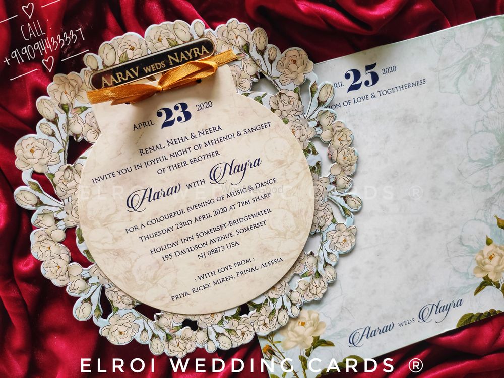 Photo From Beautiful floral design round die-cut | Gold foil with two inserts tying knots ribbon | Couple name Engraved and Pasting Gold Aycralic | Cover floral design printed. - By ELROI Wedding Cards 