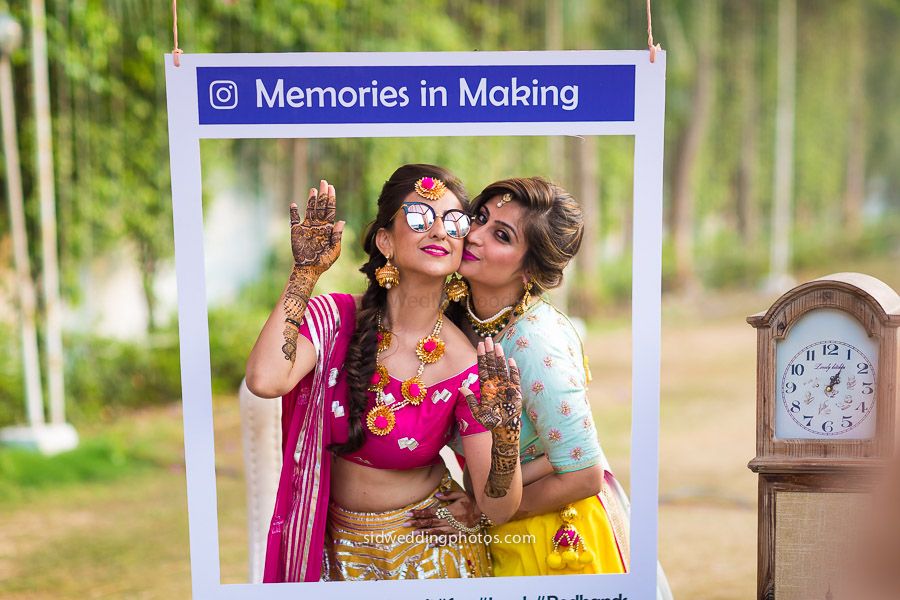 Photo of Fun bridal mehendi portrait with sister in instagram photobooth