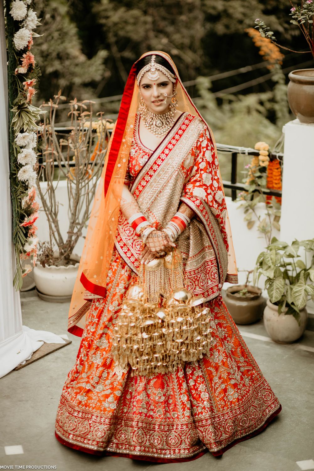 Photo of sikh bride in red and orange lehenga with a banrasi dupatta