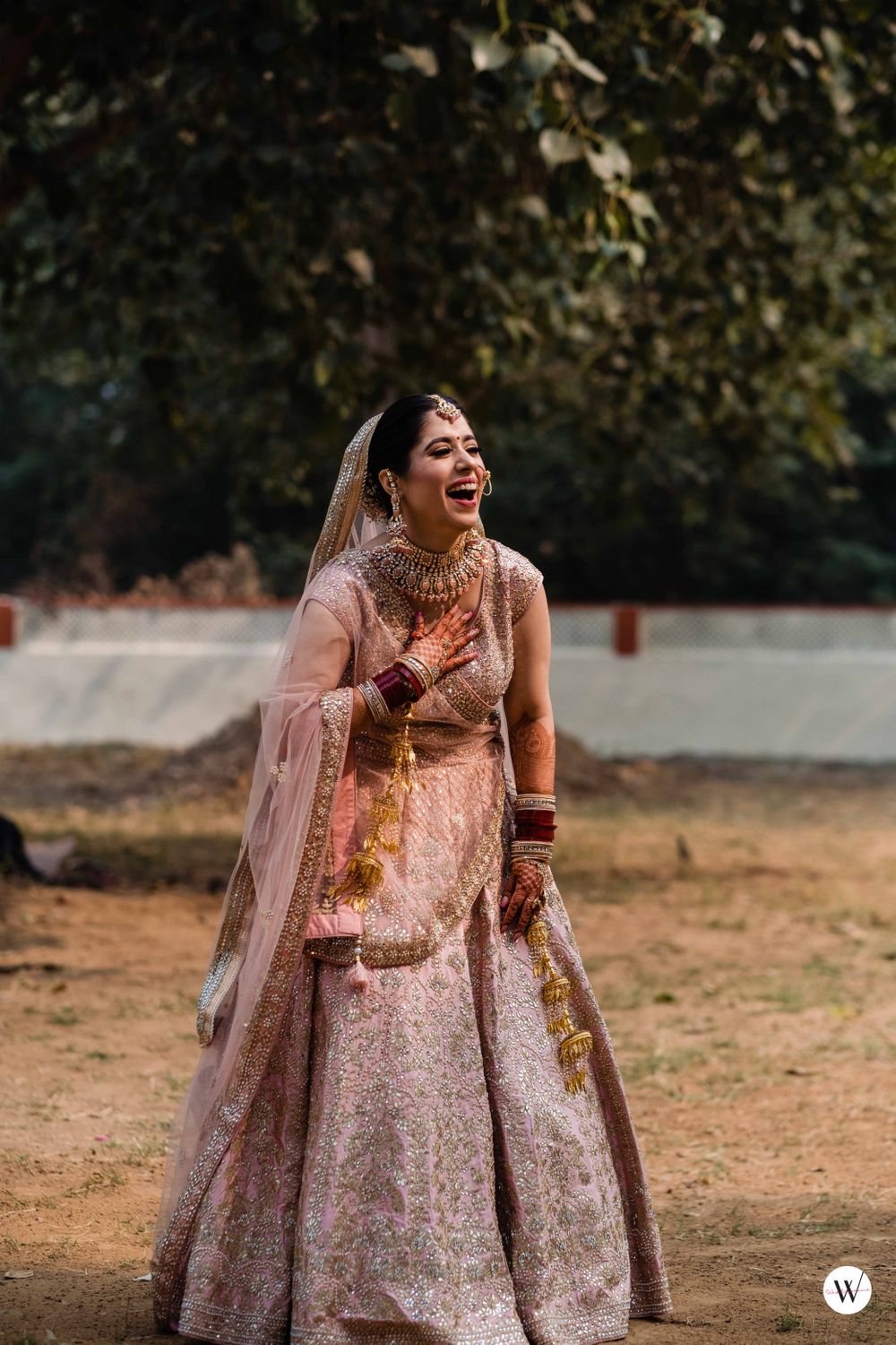 Photo of Candid bridal shot on wedding day with a bride in a pastel lehenga
