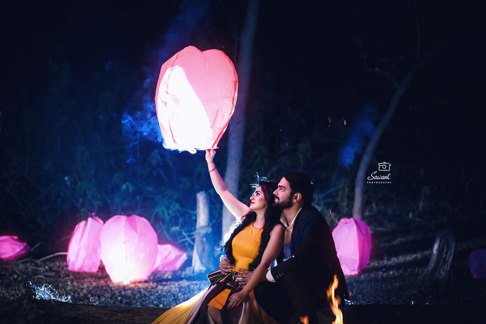 Photo of Couple releasing lantern pre wedding shoot prop