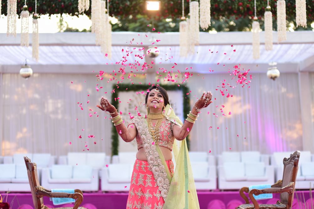 Photo of Cute bridal photo idea with bride throwing rose petals