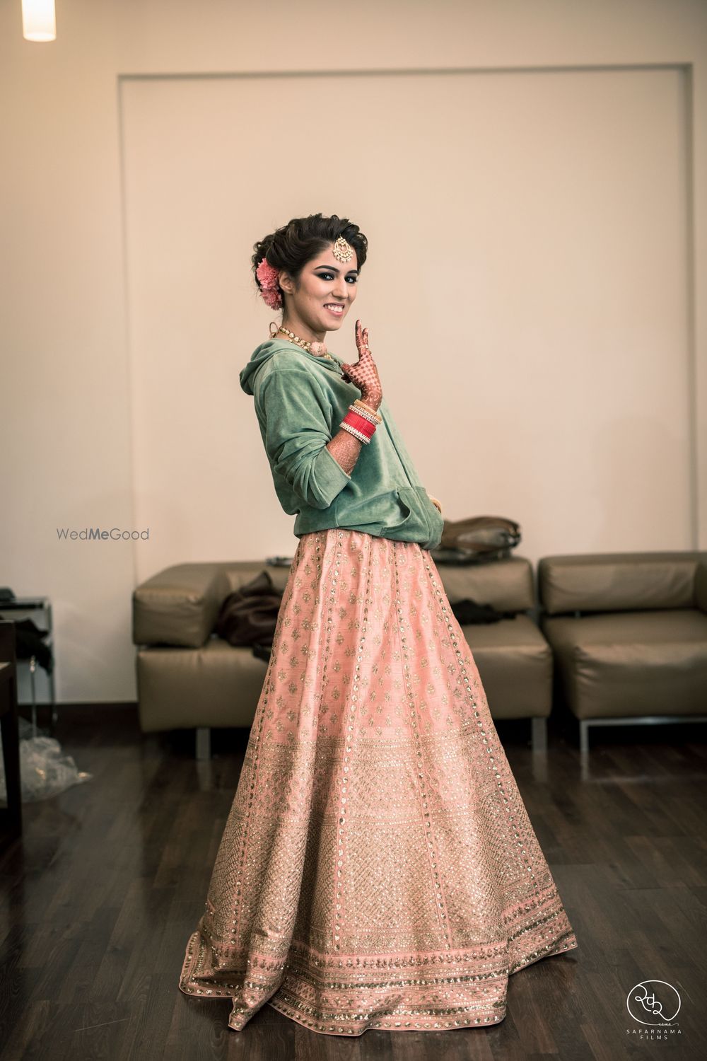 Photo of Bride getting ready in peach lehenga