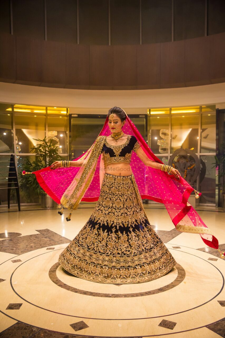 Photo of Blue velvet bridal lehenga with gold work and pink dupatta