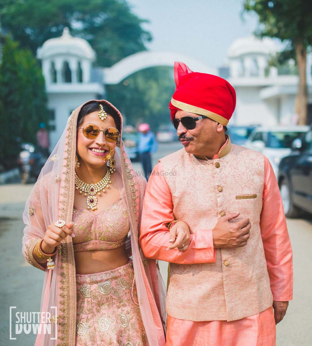 Photo of bride wearing peach and gold lehenga